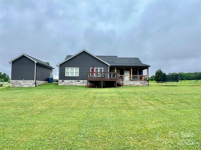 7133 Church Rd, Taylorsville, NC 28681 - back of house featuring crawl space, a trampoline, a lawn, and a deck