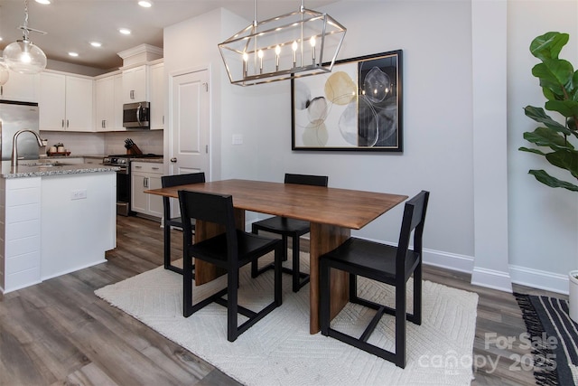 512 Morrows Turnout Way, Pineville, NC 28134 - dining space featuring dark wood-type flooring, recessed lighting, baseboards, and a chandelier