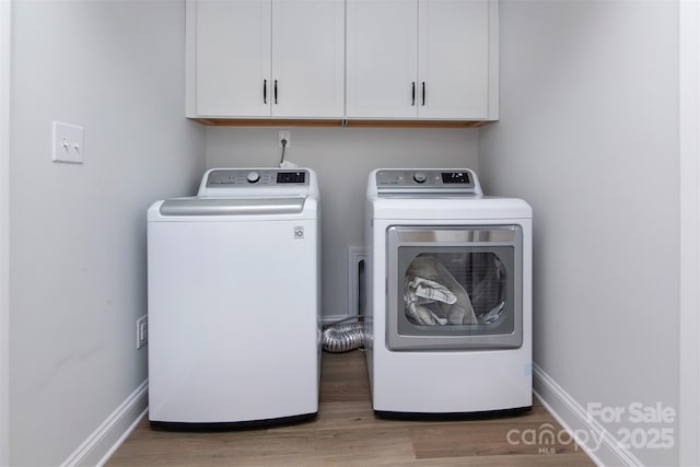 512 Morrows Turnout Way, Pineville, NC 28134 - laundry area featuring cabinet space, washing machine and dryer, wood finished floors, and baseboards