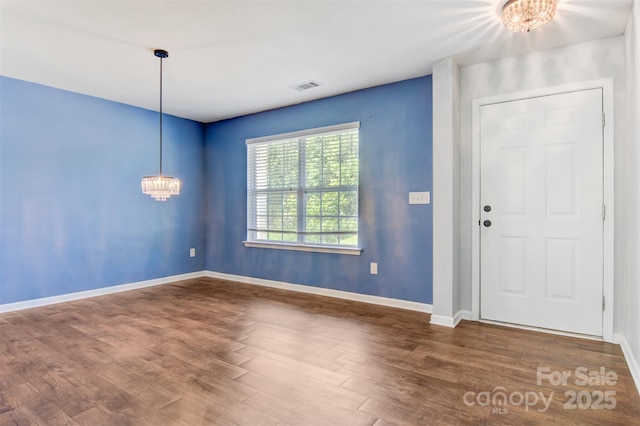 5311 Oakdale Ridge Rd, Charlotte, NC 28216 - foyer entrance featuring a chandelier, wood finished floors, and baseboards