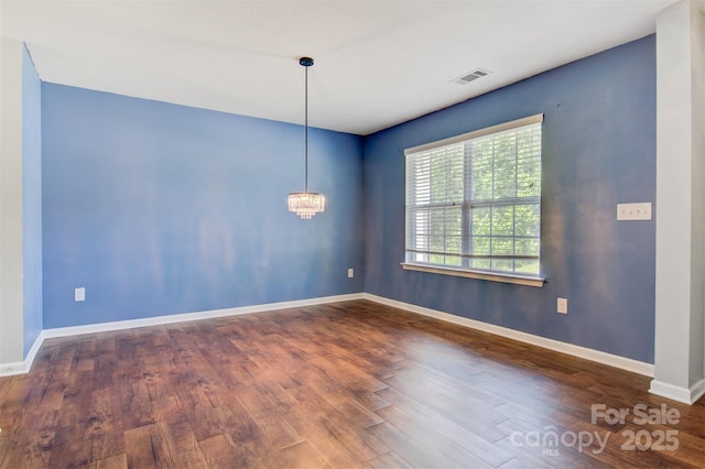 5311 Oakdale Ridge Rd, Charlotte, NC 28216 - unfurnished room with wood finished floors, baseboards, and a chandelier