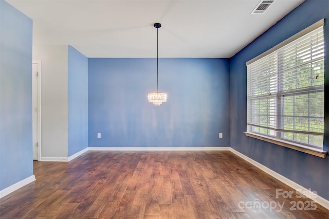 5311 Oakdale Ridge Rd, Charlotte, NC 28216 - empty room featuring a chandelier, wood finished floors, and baseboards