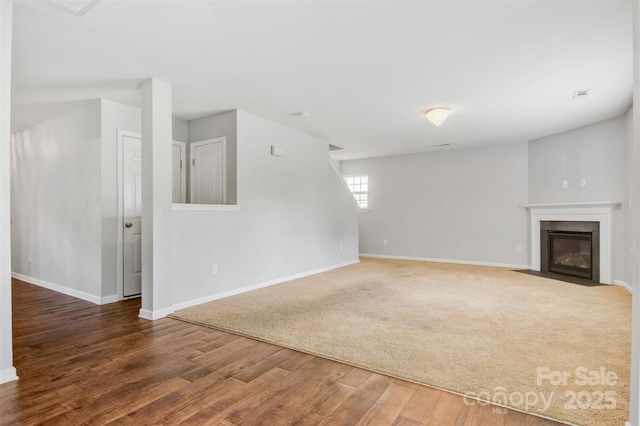 5311 Oakdale Ridge Rd, Charlotte, NC 28216 - unfurnished living room with baseboards, wood finished floors, and a fireplace with flush hearth
