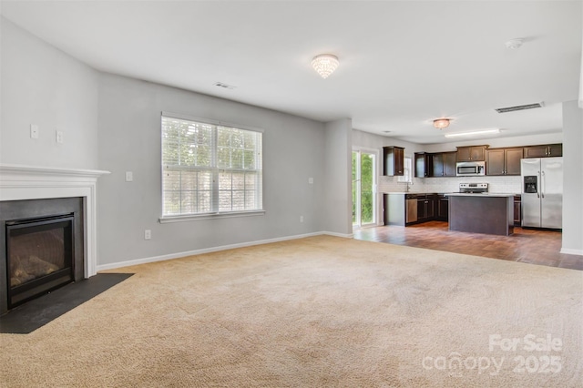 5311 Oakdale Ridge Rd, Charlotte, NC 28216 - unfurnished living room with carpet floors, a fireplace with flush hearth, and baseboards
