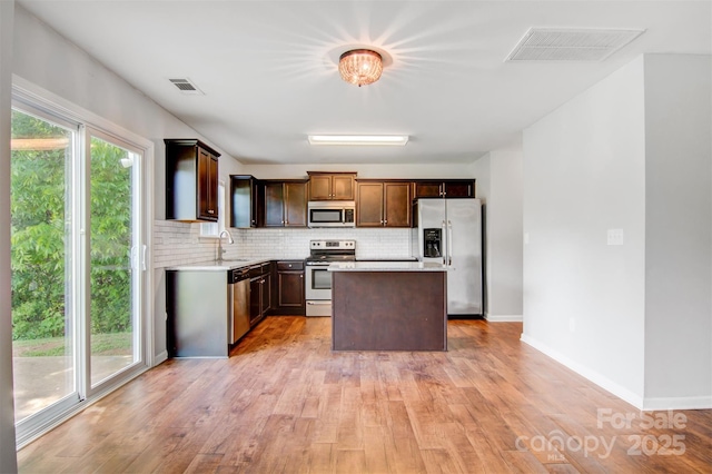 5311 Oakdale Ridge Rd, Charlotte, NC 28216 - kitchen featuring appliances with stainless steel finishes, a sink, backsplash, and light countertops