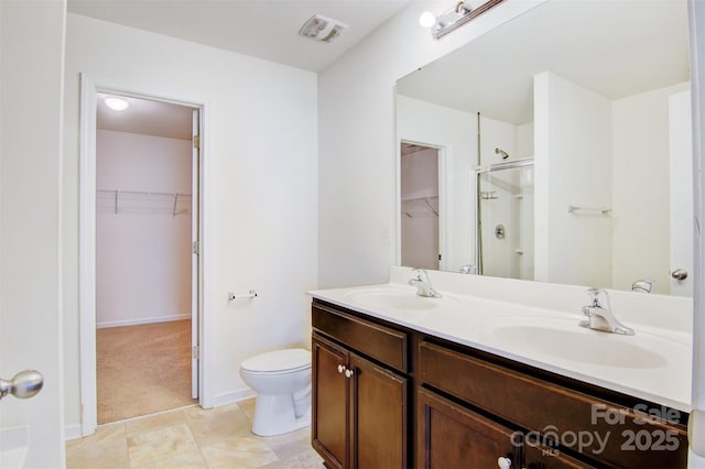 5311 Oakdale Ridge Rd, Charlotte, NC 28216 - full bathroom with a walk in closet, a shower stall, double vanity, toilet, and tile patterned floors