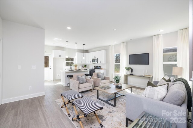 7805 Shadow Lawn Rd, Charlotte, NC 28269 - living area featuring light wood-type flooring, recessed lighting, and baseboards