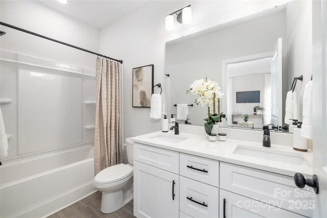 7805 Shadow Lawn Rd, Charlotte, NC 28269 - full bathroom with shower / bath combo with shower curtain, double vanity, toilet, and wood finished floors