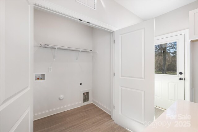 7805 Shadow Lawn Rd, Charlotte, NC 28269 - laundry area featuring gas dryer hookup, electric dryer hookup, light wood-style floors, washer hookup, and baseboards