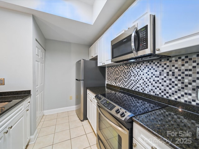 300 W 5th St Unit 339, Charlotte, NC 28202 - kitchen featuring appliances with stainless steel finishes, decorative backsplash, white cabinets, and light tile patterned flooring
