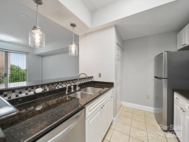 300 W 5th St Unit 339, Charlotte, NC 28202 - kitchen with a sink, appliances with stainless steel finishes, white cabinetry, pendant lighting, and light tile patterned flooring
