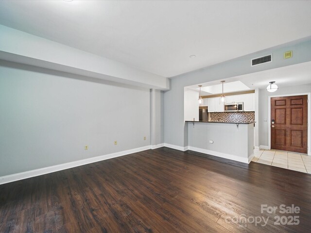 300 W 5th St Unit 339, Charlotte, NC 28202 - unfurnished living room with wood finished floors and baseboards