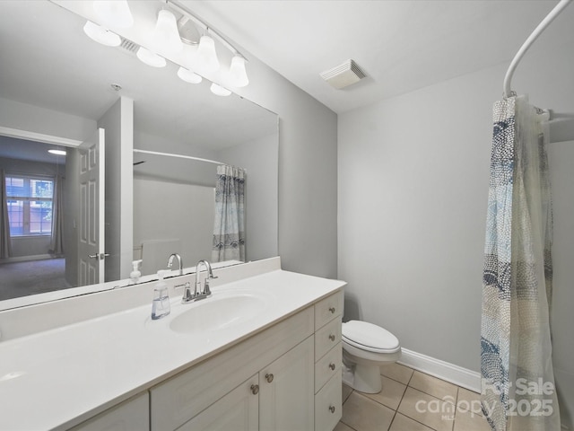 300 W 5th St Unit 339, Charlotte, NC 28202 - bathroom featuring vanity, toilet, a shower with curtain, and tile patterned floors
