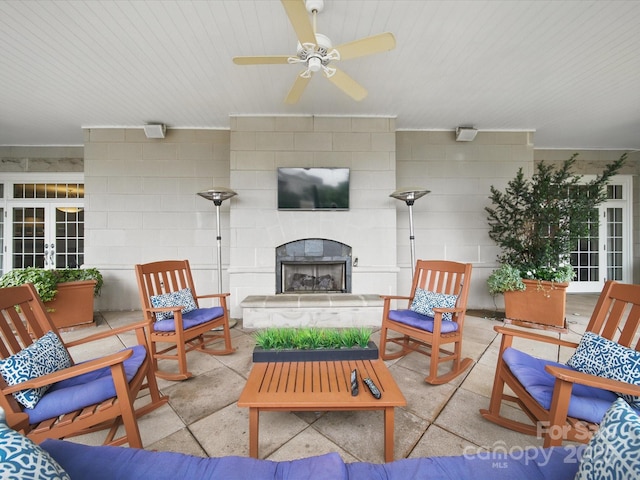 300 W 5th St Unit 339, Charlotte, NC 28202 - view of patio featuring french doors, a ceiling fan, and an outdoor living space with a fireplace