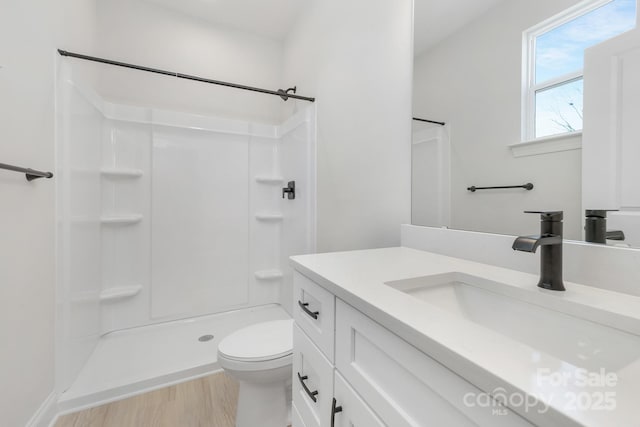 6327 Carver Blvd, Charlotte, NC 28269 - bathroom featuring vanity, toilet, a shower, and wood finished floors