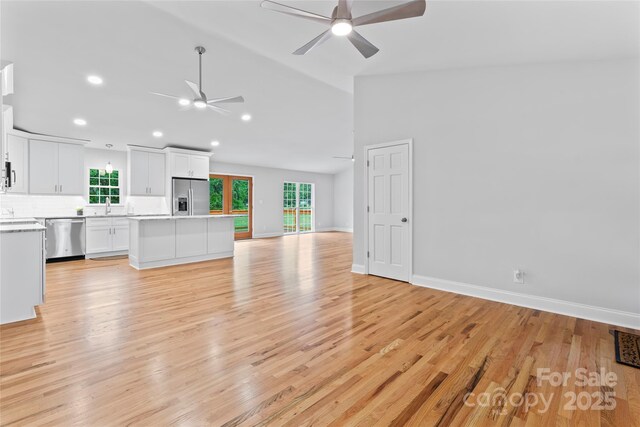 105 Pelican Ct, Mooresville, NC 28117 - unfurnished living room featuring ceiling fan, a sink, light wood-type flooring, recessed lighting, and lofted ceiling