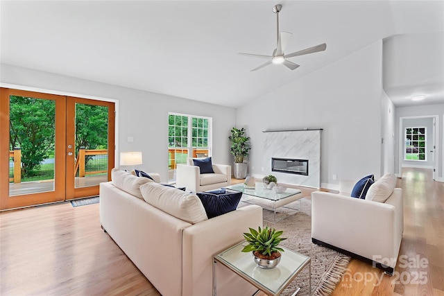 105 Pelican Ct, Mooresville, NC 28117 - living area with light wood-type flooring, a ceiling fan, french doors, a premium fireplace, and high vaulted ceiling