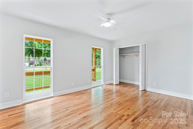 105 Pelican Ct, Mooresville, NC 28117 - unfurnished bedroom featuring multiple windows, wood finished floors, baseboards, and ceiling fan