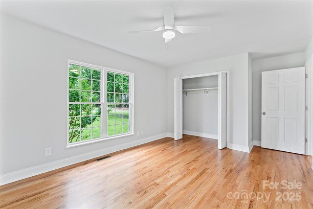 105 Pelican Ct, Mooresville, NC 28117 - unfurnished bedroom with baseboards, light wood-type flooring, a closet, and a ceiling fan