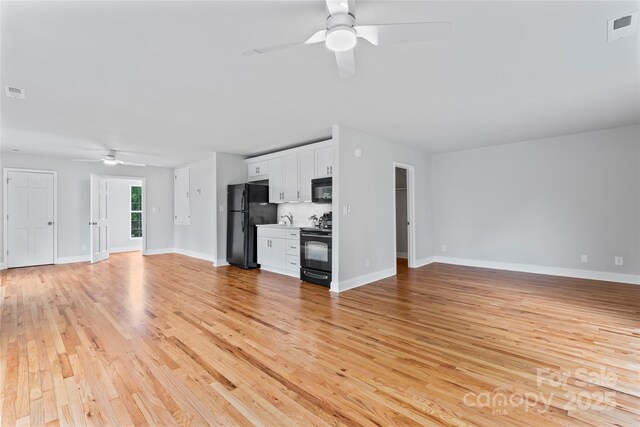 105 Pelican Ct, Mooresville, NC 28117 - unfurnished living room featuring a ceiling fan, light wood-type flooring, and baseboards