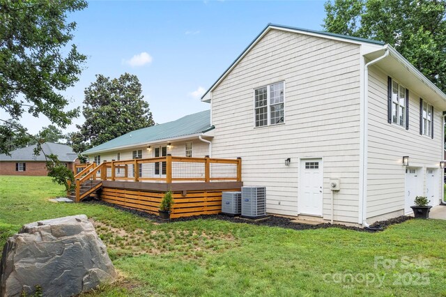 105 Pelican Ct, Mooresville, NC 28117 - rear view of property featuring a deck, a lawn, central air condition unit, and a garage