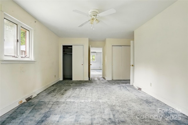 6900 Ridge Lane Rd, Charlotte, NC 28262 - unfurnished bedroom with multiple closets, multiple windows, carpet flooring, and baseboards