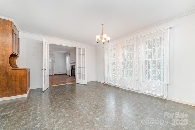 520 Eastwood Park Cir, Albemarle, NC 28001 - unfurnished living room with french doors, baseboards, a chandelier, and ornamental molding