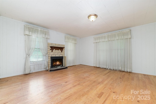 520 Eastwood Park Cir, Albemarle, NC 28001 - unfurnished living room featuring wood finished floors and a lit fireplace