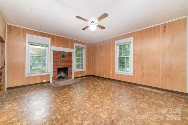 520 Eastwood Park Cir, Albemarle, NC 28001 - unfurnished living room with crown molding, ceiling fan, wood walls, baseboards, and a brick fireplace