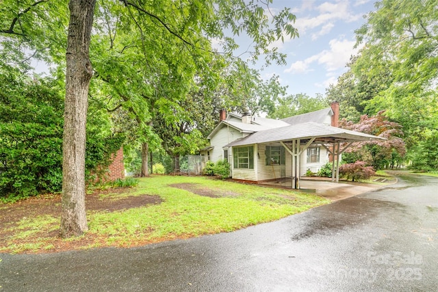 520 Eastwood Park Cir, Albemarle, NC 28001 - view of front facade with a chimney, driveway, and a carport