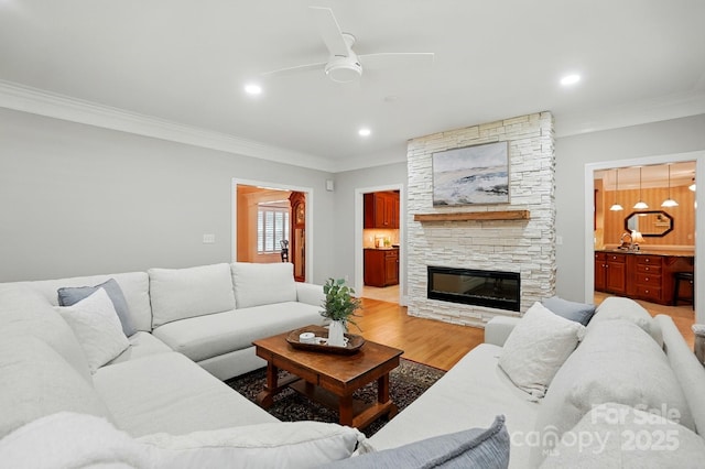 102 Rosewood Ln, Locust, NC 28097 - living room with ornamental molding, ceiling fan, a stone fireplace, light wood-style floors, and recessed lighting