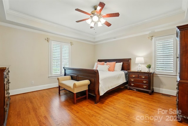 102 Rosewood Ln, Locust, NC 28097 - bedroom featuring light wood-type flooring, a tray ceiling, baseboards, ornamental molding, and a ceiling fan