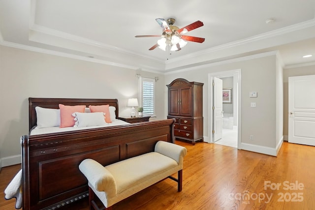102 Rosewood Ln, Locust, NC 28097 - bedroom with light wood-style floors, a raised ceiling, crown molding, connected bathroom, and baseboards