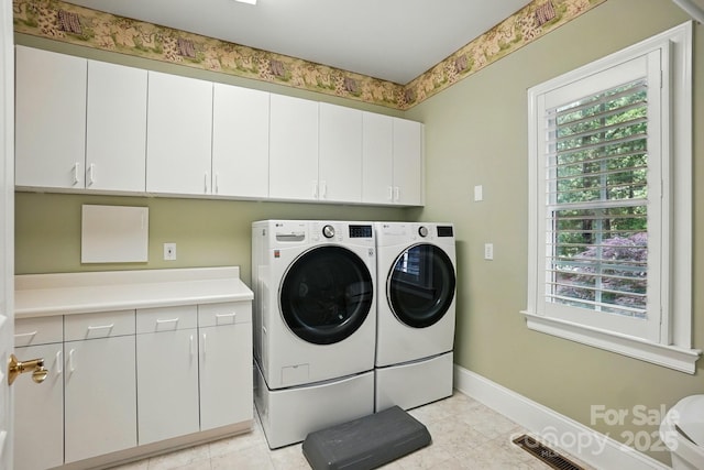 102 Rosewood Ln, Locust, NC 28097 - laundry area featuring cabinet space, washer and clothes dryer, plenty of natural light, and baseboards