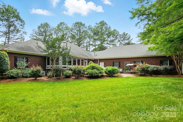 102 Rosewood Ln, Locust, NC 28097 - rear view of house featuring brick siding, a yard, and roof with shingles