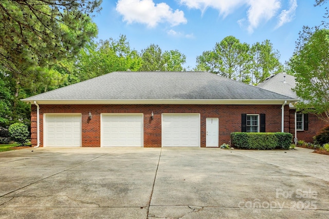 102 Rosewood Ln, Locust, NC 28097 - view of property exterior with concrete driveway, roof with shingles, and brick siding