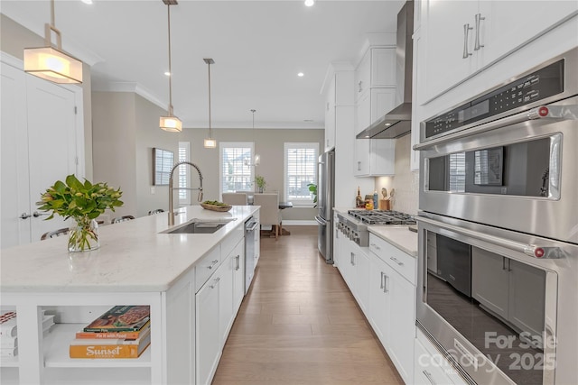 5060 Harrowsmith Ln, Charlotte, NC 28204 - kitchen featuring a sink, stainless steel appliances, wall chimney range hood, crown molding, and a center island with sink