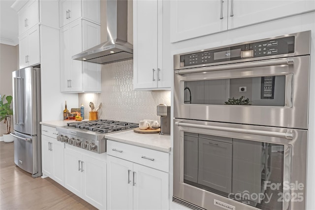 5060 Harrowsmith Ln, Charlotte, NC 28204 - kitchen featuring appliances with stainless steel finishes, wall chimney range hood, backsplash, white cabinets, and light stone counters