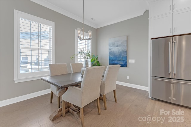 5060 Harrowsmith Ln, Charlotte, NC 28204 - dining space with light wood-style flooring, baseboards, a chandelier, and ornamental molding
