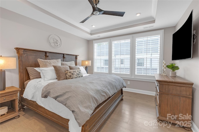 5060 Harrowsmith Ln, Charlotte, NC 28204 - bedroom featuring a raised ceiling, baseboards, light wood-type flooring, ceiling fan, and recessed lighting