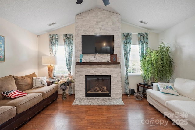 119 Ashwood Ln, Mooresville, NC 28117 - living area with lofted ceiling, a stone fireplace, wood finished floors, a textured ceiling, and a ceiling fan
