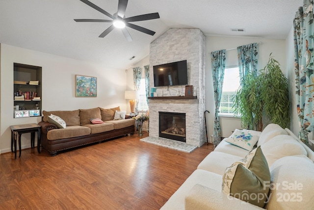 119 Ashwood Ln, Mooresville, NC 28117 - living area with lofted ceiling, ceiling fan, wood finished floors, and a fireplace