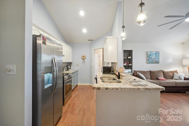 119 Ashwood Ln, Mooresville, NC 28117 - kitchen with stainless steel appliances, vaulted ceiling, white cabinetry, a peninsula, and a ceiling fan