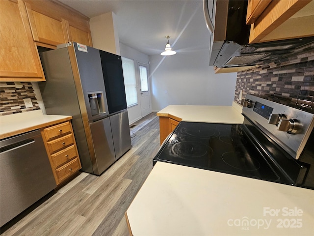 606 N St, Belmont, NC 28012 - kitchen with appliances with stainless steel finishes, tasteful backsplash, light wood-type flooring, light countertops, and brown cabinetry