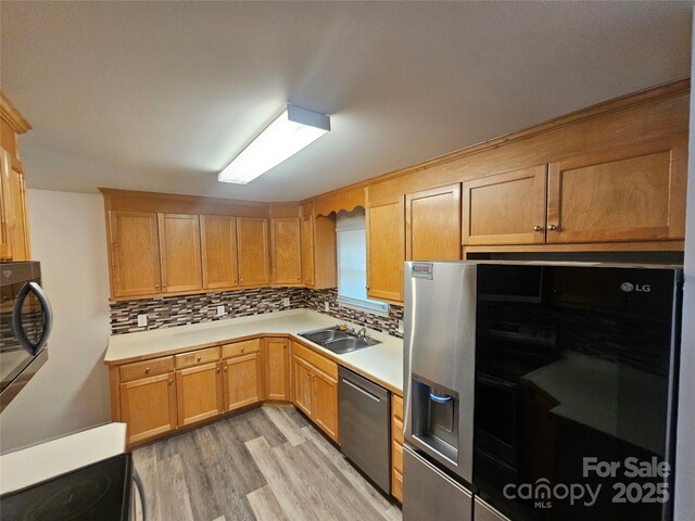 606 N St, Belmont, NC 28012 - kitchen with stainless steel appliances, light wood-style floors, decorative backsplash, and light countertops