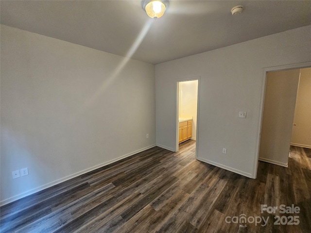 606 N St, Belmont, NC 28012 - unfurnished bedroom featuring dark wood-type flooring and connected bathroom