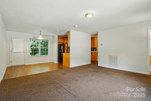606 N St, Belmont, NC 28012 - unfurnished living room with carpet and baseboards