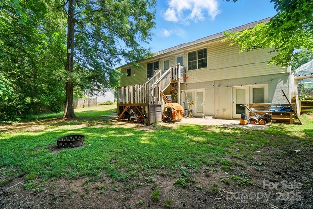 606 N St, Belmont, NC 28012 - rear view of house featuring a fire pit, stairway, and a patio