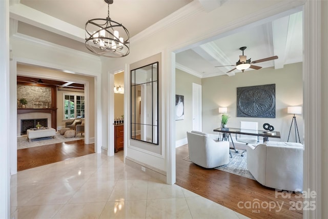 3032 Kings Manor Dr, Matthews, NC 28104 - living area with crown molding, a stone fireplace, a chandelier, beam ceiling, and ceiling fan
