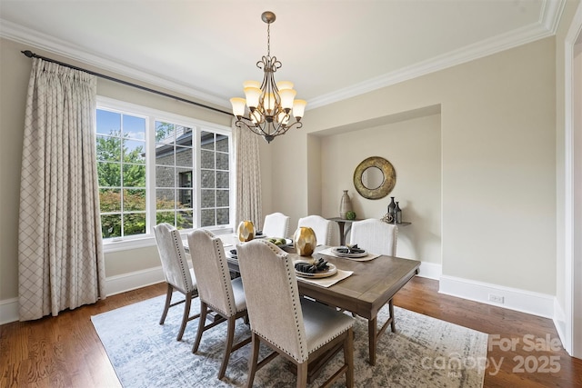 3032 Kings Manor Dr, Matthews, NC 28104 - dining space with a chandelier, ornamental molding, and wood finished floors